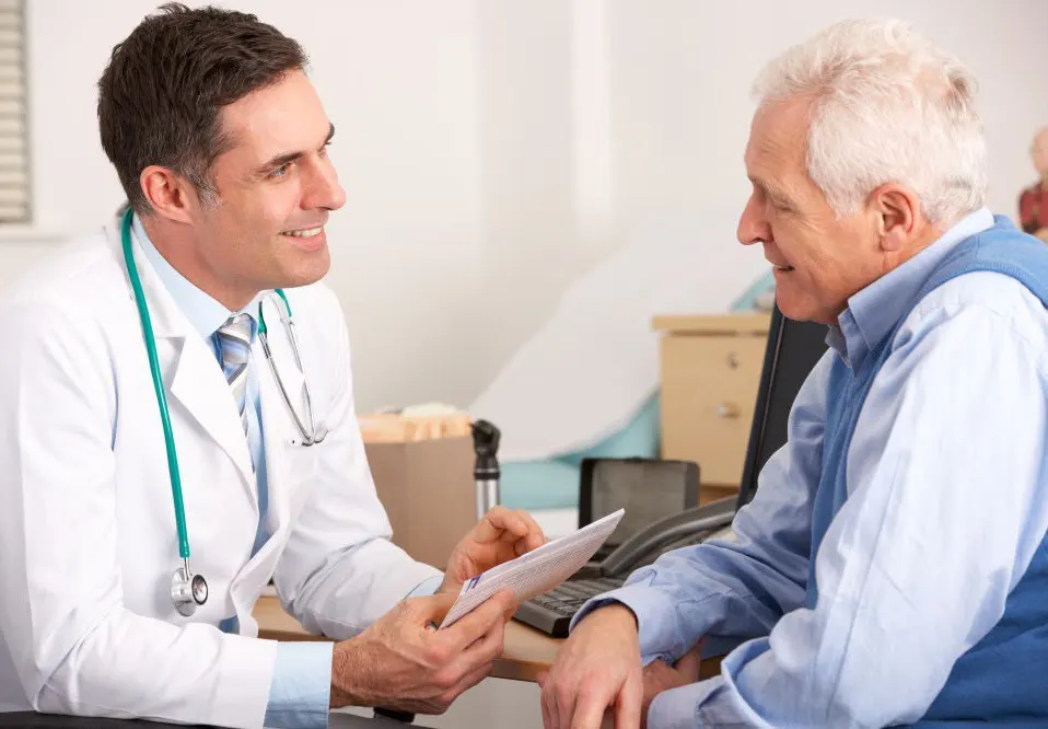 A doctor consults with an elderly patient.