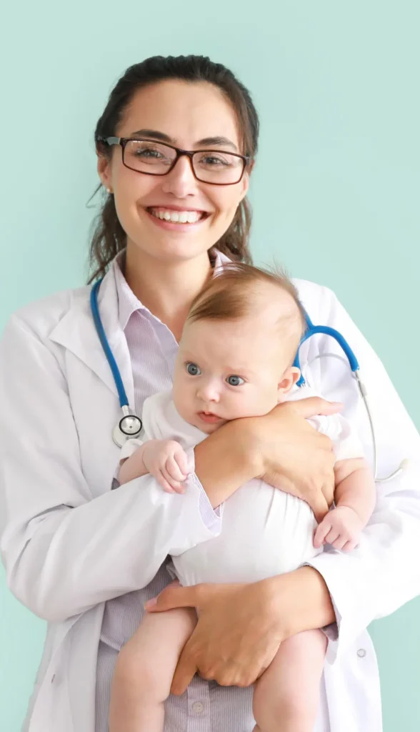 A doctor holds a baby.