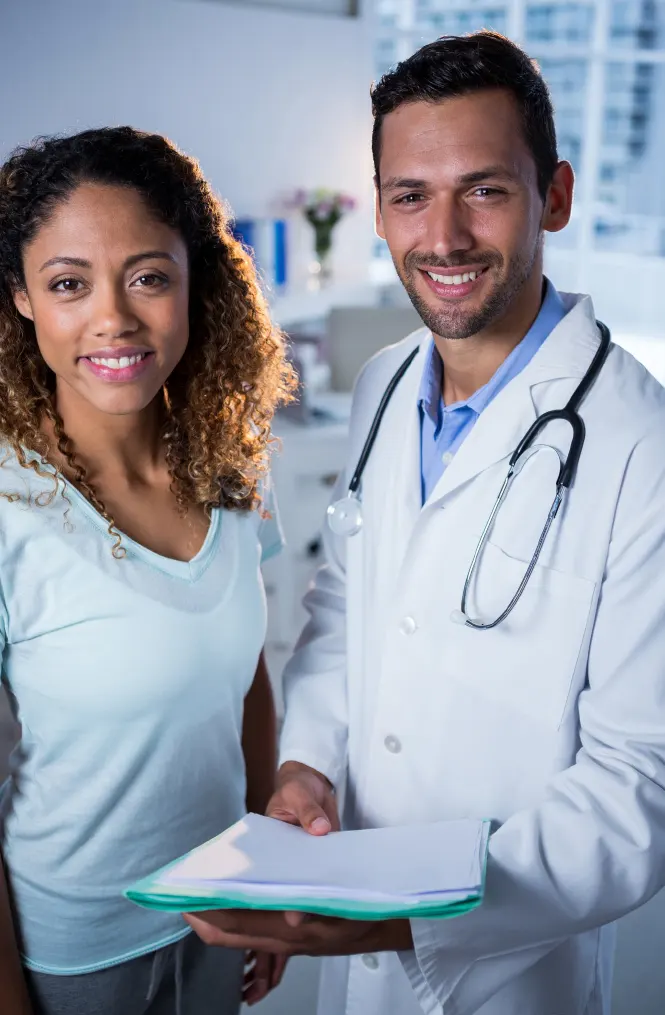 A doctor and patient smile.